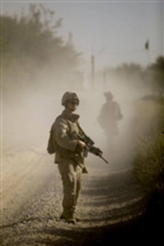 U.S. Marine Corps Cpl. Hodys, a communication technician with the 1st Battalion, 5th Marine Regiment, provides security during a patrol in the Nawa district of Afghanistan's Helmand province on Aug. 13, 2009.  The 1st Battalion, 5th Marine Regiment is deployed with Regimental Combat Team 3, which conducts counter insurgency operations in partnership with Afghan National Security Forces in southern Afghanistan.  