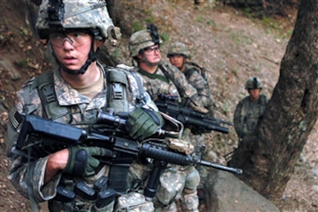 U.S. Army Sgt. Matthew Roberts and fellow soldiers patrol the Korengal valley during the early morning hours in Kunar province, Afghanistan, Aug. 13, 2009. Roberts is assigned to the 4th Infantry Division's Company B, 2nd Battalion, 12th Infantry Regiment, 4th Brigade Combat Team.