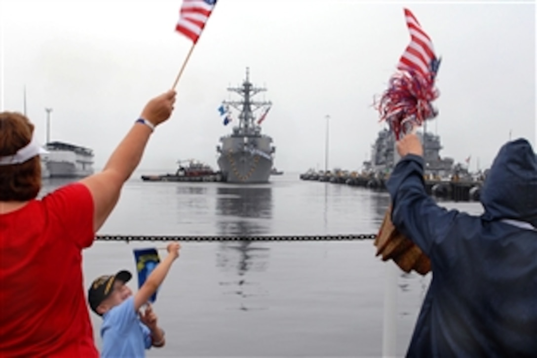 Family members and friends wait on the pier in Norfolk, Va., Aug. 14, 2009, for the return of the USS Mitscher after a 200-day deployment. The Mitscher deployed as the only American ship supporting a Royal Navy Amphibious Task Group conducting ongoing Joint Special Operations in the Far East.