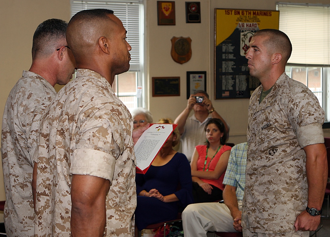 First Lt. Christopher M. Young (right), the Combined Anti-Armor Team platoon commander with Weapons Company, 1st Battalion, 6th Marine Regiment, 2nd Marine Division, stands before Col. Paul J. Kennedy, the 2nd Marine Regiment commanding officer, and Lt. Col.  Calvert L. Worth Jr., the 1/6 commanding officer, as he is presented the Bronze Star Medal with combat distinguishing device, Aug. 14, 2009.  Young received the award for his combat actions while serving in Garmsir District, Helmand Province, Afghanistan during March 15 to Aug. 10, 2008, in support of Operation Azada Wosa.  Within the first 30 days of the operation, as a second lieutenant, Young led his Marines on 40 direct-fire engagements, protected his Marines and accomplished other achievements in connection with combat operations against the enemy as platoon commander of 3rd platoon, Company A, Battalion Landing Team, 1st Battalion, 6th Marines, 24th Marine Expeditionary Unit.