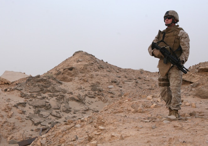 Sgt. Justin D. Toren, a driver and operator for the 2nd Marine Logistics Group (Forward) commanding general’s personal security detail, poses in full personal protective equipment aboard Camp Al Taqaddum, Iraq, Aug. 14, 2009.  Toren, who was deployed to Iraq during the invasion, joined the Marine Corps following the Sept. 11 terrorist attacks.  (U.S. Marine Corps photograph by Lance Cpl. Melissa A. Latty)