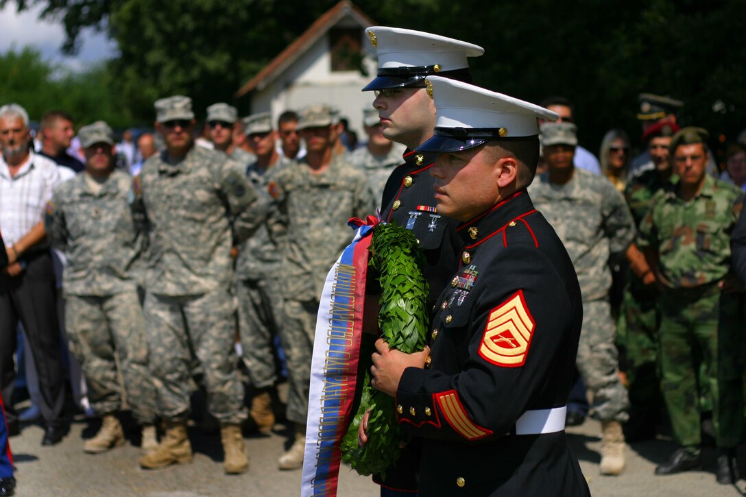 Marine Security Guards for the U.S. Embassy in Belgrade, Serbia Lance  Aaron Johnston and Gunnery Sgt. Laureano Perez lay a wreath at the Halyard Mission memorial in Pranjanje, Serbia, Aug 15, 2009 during the 65th annivesary of the Halyard mission.
