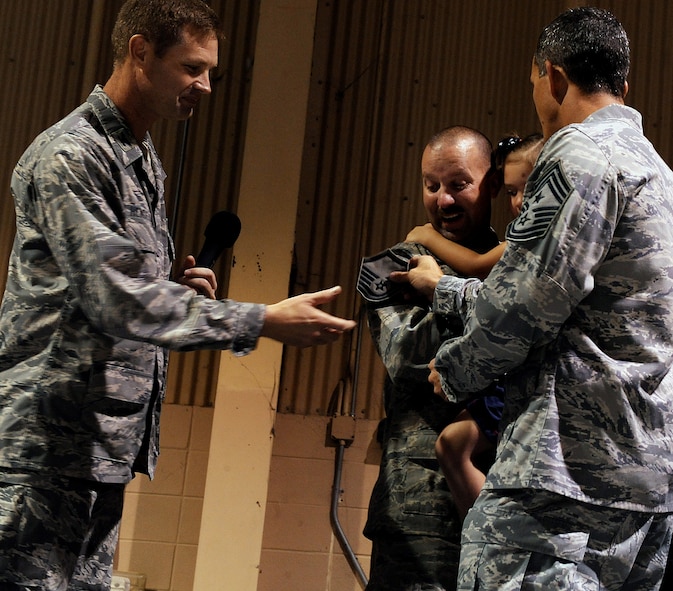 MOODY AIR FORCE BASE, Ga. – (Left) Col. Gary Henderson, 23rd Wing commander, along with (far right) Chief Master Sgt. Richard Parsons, 23rd Wing command chief master sergeant, surprise (middle) Tech. Sgt. Ronald Sprading, 23rd Equipment Maintenance Squadron aircraft structural maintainer, who has just returned from a six-month deployment, with the news that he has been selected for the Stripes for Exceptional Performers program here Aug. 15. Sergeant Sprading will be promoted to the rank of master sergeant. (U.S. Air Force photo by Airman 1st Class Joshua Green)