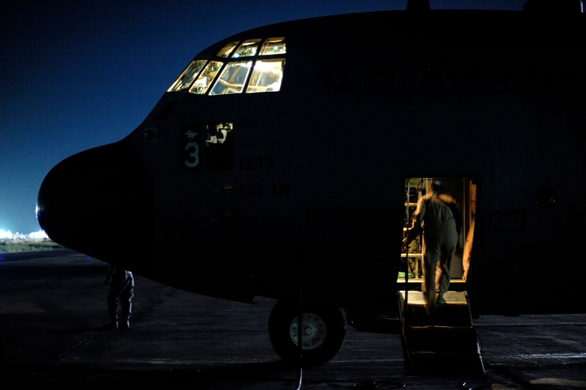 BAGRAM AIRFIELD, Afghanistan - Airman 1st Class Megan Curtis, a Fly Away Security Team (FAST) member, boards a C-130H Hercules aircraft, Aug. 13, 2009.  FASTs are a select few of the 455th Expeditionary Security Forces Squadron from Bagram AF that are responsible for the security of an aircraft, it's crew, and cargo at unsecured airfields. (U.S. Air Force photo/Staff Sgt. Michael B. Keller)