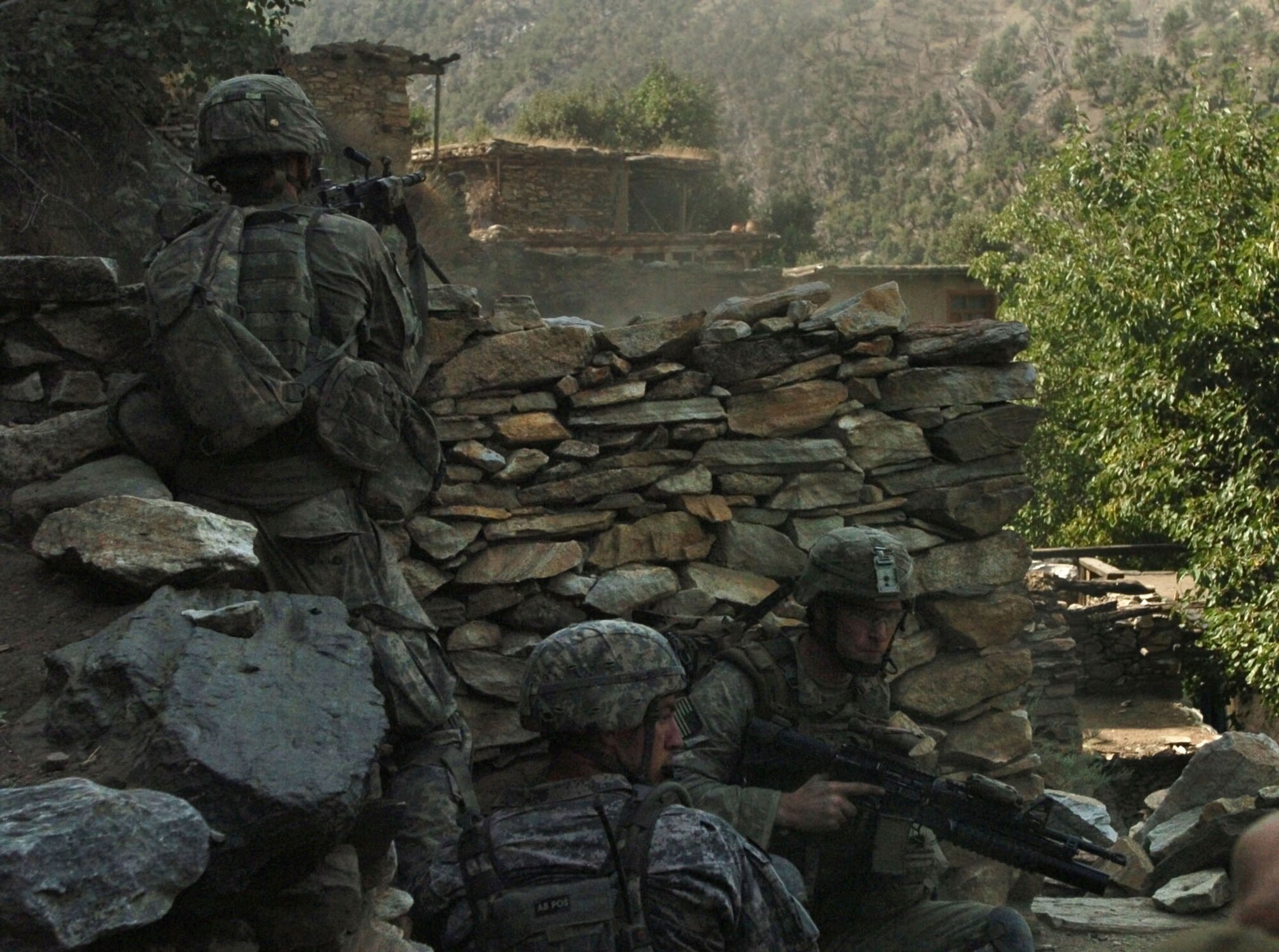 KUNAR PROVINCE, Afghanistan - U.S. Army and Air Force personnel assigned to Company B, 2nd Battalion, 12th Infantry Regiment, 4th Brigade Combat Team, 4th Infantry Division, return fire at insurgent positions in the Korengal valley's steep hillside in Afghanistan's Kunar province, August 13. The 20 minute gun battle ended with 500 pound bombs, dropped by U.S. Air Force F-15 fighter jets, destroying insurgent positions in the surrounding hills. No civilians were injured during the battle. International Security Assistance Forces across Afghanistan have increased operations in recent months, in order to ensure safety and security during Afghanistan's second national election, scheduled for the end of August. (U.S. Army photo/Sgt. Matthew Moeller)