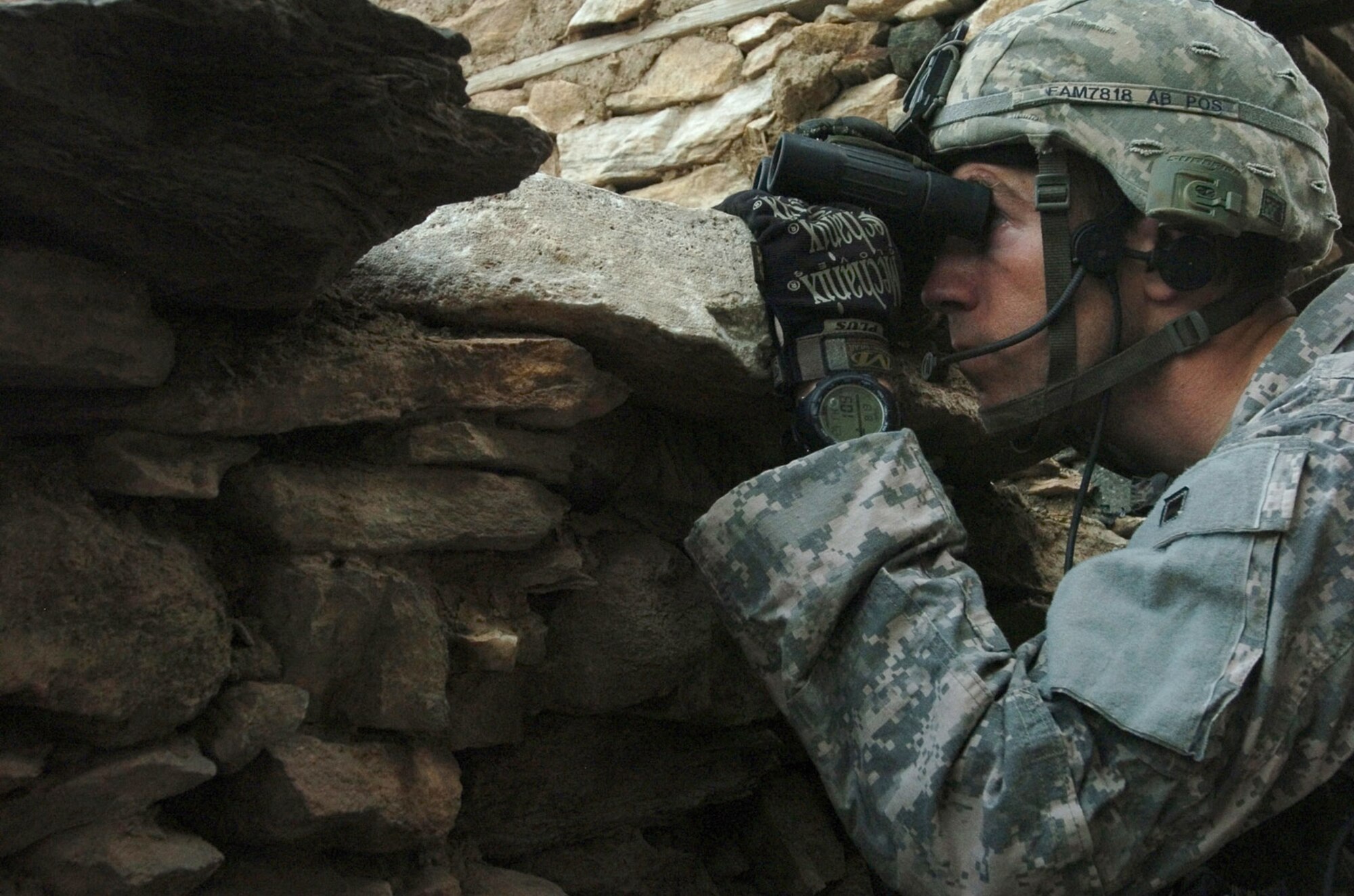 KUNAR PROVINCE, Afghanistan - Tech. Sgt. Joel McPherson, a native of Knoxville, Tenn., scans the Korengal valley's steep hills for insurgents in Afghanistan's Kunar province, August 13. Moments later, McPherson and fellow members of Company B, 2nd Battalion, 12th Infantry Regiment, 4th Brigade Combat Team, 4th Infantry Division, were attacked. The 20 minute gun battle ended with 500 pound bombs, dropped by U.S. Air Force F-15 Fighter Jets, destroying insurgent positions in the surrounding hills. No civilians were injured. International Security Assistance Forces across Afghanistan have increased operations in recent months, in order to ensure safety and security during Afghanistan's second national election, scheduled for the end of August. (U.S. Army photo/Sgt. Matthew Moeller)
