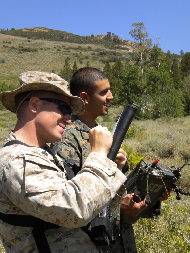 Grinning about the hit or miss nature of communications, Sgt. Dick Lagerquist, a Yakima, Wash., native and instructor at the Mountain Command and Control Communications Course at MCMWTC, annotates the team's success at establishing Grinning about the hit or miss nature of communications, Sgt. Dick Lagerquist, a Yakima, Wash., native, and instructor at the Mountain Command and Control Communications Course at Marine Corps Mountain Warfare Training Center Bridgeport, Calif., annotates the team's success at establishing communications with an unseen radio operator located at base camp Aug. 15. After 20 minutes of unsuccessful attempts, the team moved 20 feet and immediately completed the task.