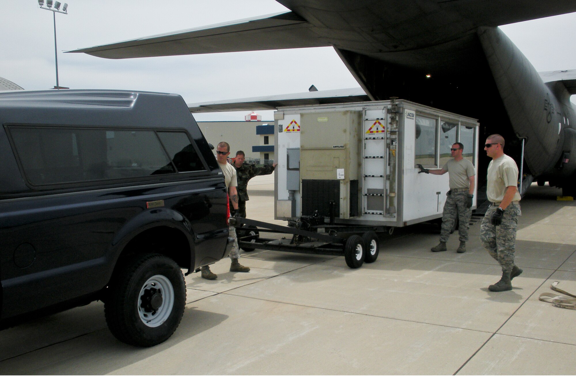 Members of Kentucky Air Guard's 123rd Contingency Response Group off-load a mobile command post as part of Operation Ardent Sentry.