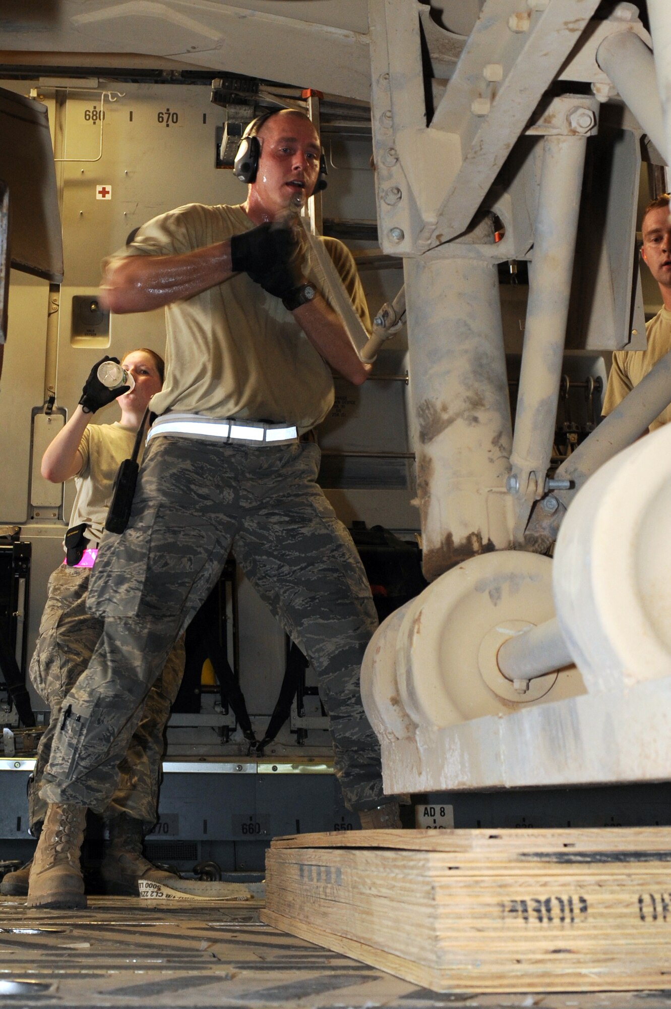 SOUTHWEST ASIA -Tech. Sgt. Andrew McMahon, 380th Expeditionary Logistics Readiness Squadron, Air Terminal Operations Center Craftsman, turns a handle to raise the legs on a cargo trailer loaded on a C-17 aircraft Aug 14. Sergeant McMahon is deployed from Andrews AFB, Md., and hails from Van Wert, Ohio. (U.S. Air Force photo/Tech. Sgt. Charles Larkin Sr)