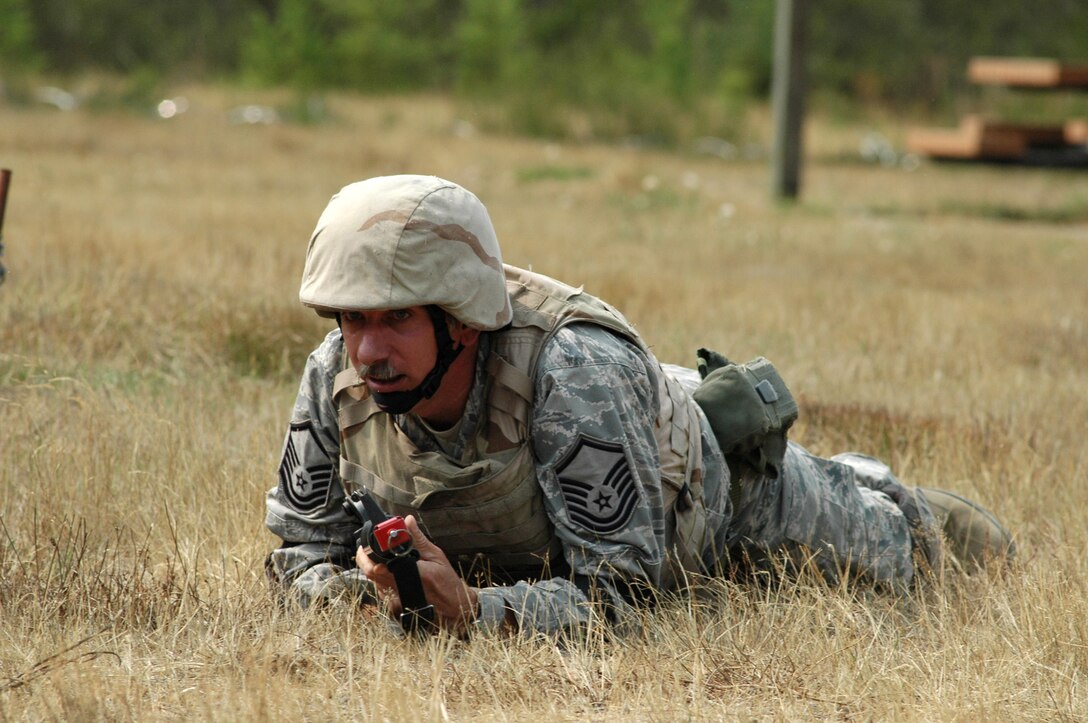 Master Sgt. Carl Hayden, supply manager for the 446th Civil Engineer Squadron, McChord Air Force Base, Wash., high crawls his way through combat skills training at Fort Lewis, Wash. The 446th CES is going through CST as one of their last few requirements before deploying to Iraq at the end of this month as part of their air expeditionary force rotation. (U.S. Air Force photo/Tech. Sgt. Jake Chappelle)