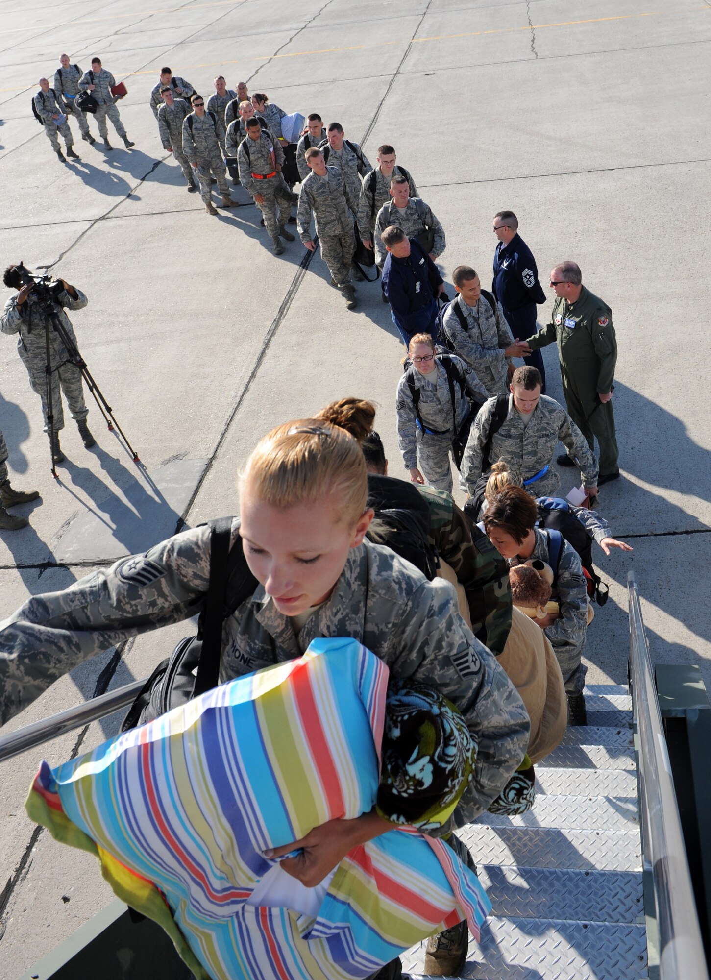 MOUNTAIN HOME AIR FORCE BASE, Idaho – More than 300 Airmen from the 366th Fighter Wing wait in line as they board a plane before leaving on their deployment Aug. 17. The Airmen – including aircraft maintainers and aircrews from the 389th Fighter Squadron- will deploy for approximately five months as part of a scheduled rotational deployment to Kunsan Air Base, Republic of Korea. (U.S. Air Force photo by Airman 1st Class Debbie Lockhart)