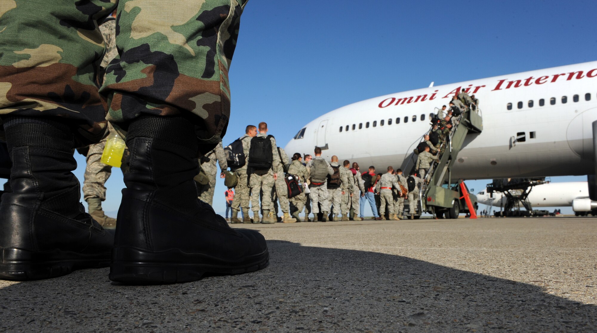 MOUNTAIN HOME AIR FORCE BASE, Idaho - More than Airmen from the 366th Fighter Wing wait in line as they board a plane before leaving on their deployment Aug. 17. The Airmen – including aircraft maintainers and aircrews from the 389th Fighter Squadron- will deploy for approximately five months as part of a scheduled rotational deployment to Kunsan Air Base, Republic of Korea. (U.S. Air Force photo by Airman 1st Class Debbie Lockhart)