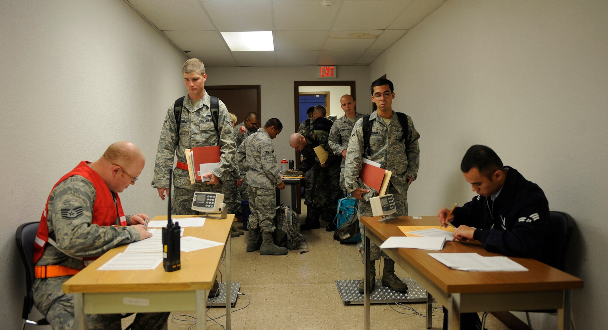MOUNTAIN HOME AIR FORCE BASE, Idaho - Airmen from the 389th Fighter Squadron wait in line as they get their temperatures taken and weighed in before deploying Aug. 17. More than 300 members of the 366th Fighter Wing – including aircraft maintainers and aircrews from the 389th Fighter Squadron- will deploy for approximately five months as part of a scheduled rotational deployment to Kunsan Air Base, Republic of Korea. (U.S. Air Force photo by Airman 1st Class Renishia Richardson)