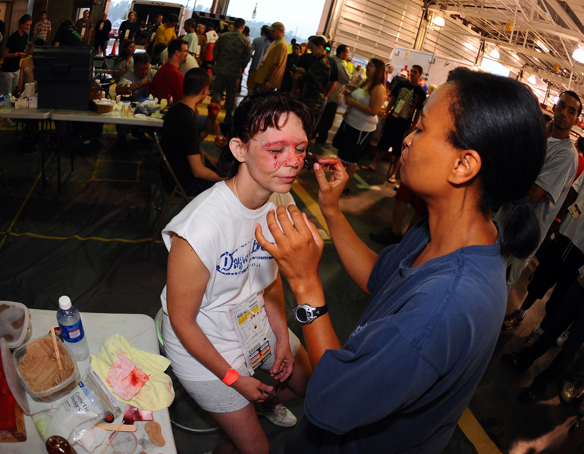 OFFUTT AIR FORCE BASE, Neb.-  Capt. Alice Tyndall, 55th Medical Group, applies makeup to simulate facial injuries to Robin Martin, an event volunteer, as part of the Major Accident Response Exercise 15 Aug.  Airman with the 55th Medical Group along with medical professionals from the surrounding Omaha metro area took part in the MARE held annually to prepare for the 2009 "Defenders of Freedom" Open House and Air Show.

U.S. Air Force Photo by Josh Plueger