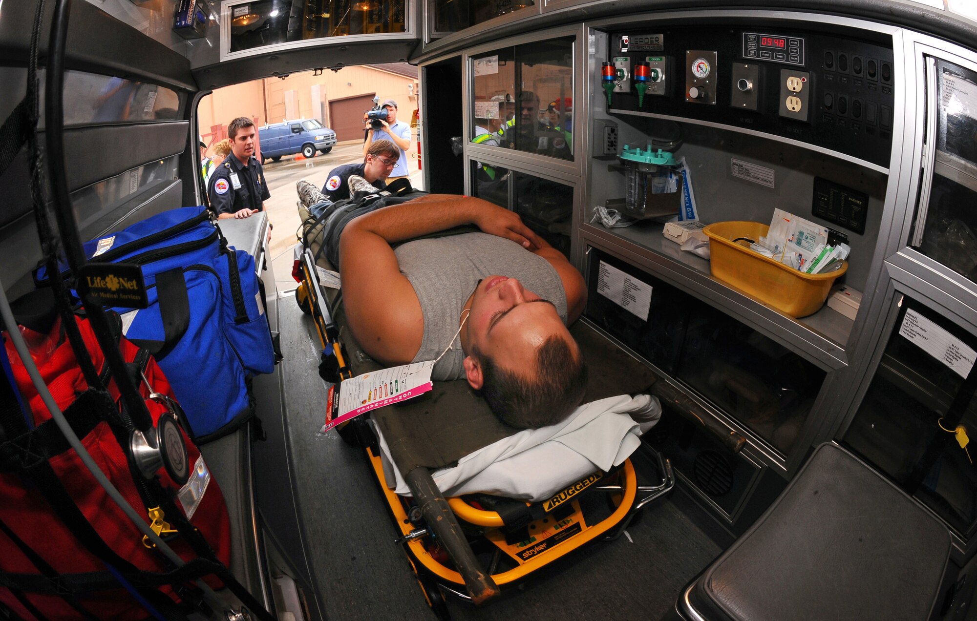 OFFUTT AIR FORCE BASE, Neb.- Pat Udron and Matt Burkey, emergency medical technicians with American Medical Response, fill their ambulance with volunteers with simulated injuries as part of the Major Accident Response Exercise Aug. 15.  Airmen with the 55th Medical Group along with medical professionals from the surrounding Omaha metro area take part in the MARE held annually prior to the "Defenders of Freedom" Open House and Air Show hosted here. U.S. Air Force photo by Josh Plueger