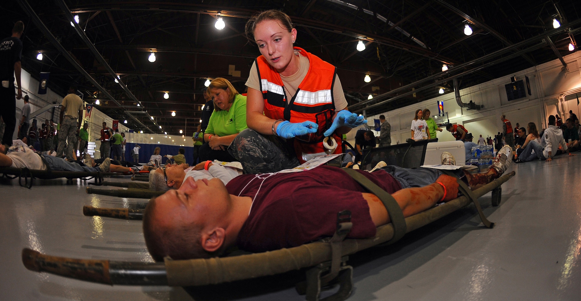 OFFUTT AIR FORCE BASE, Neb.- Tech. Sgt. Richelle Moen, independant duty medical technician for the 1st Airborne Combat and Control Squadron, treats local volunteers with a wide array of simulated injuries while participating in a Major Accident Response Exercise in the Offutt Field House, Aug. 15.  Airmen with the 55th Medical Group along with medical professionals from the surrounding Omaha metro area take part in the MARE held annually prior to the "Defenders of Freedom" Open House and Air Show hosted here. U.S. Air Force photo by Josh Plueger