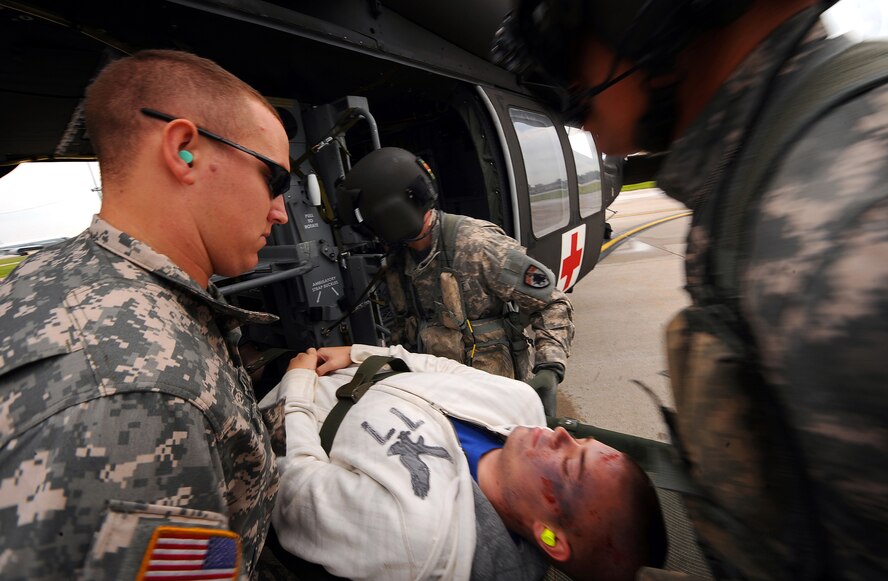 OFFUTT AIR FORCE BASE, Neb.- Soldiers with the Nebraska National Guard load volunteers with simulated injuries into two UH-60 Blackhawk helicoptors on the flightline as part of a Major Accident Response Exercise Aug. 15.  Airmen with the 55th Medical Group along with medical professionals from the surrounding Omaha metro area take part in the MARE held annually prior to the "Defenders of Freedom" Open House and Air Show hosted here. U.S. Air Force photo by Josh Plueger