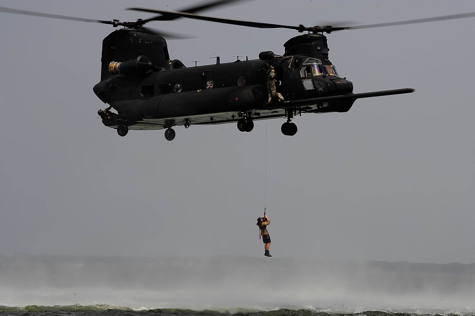 HURLBURT FIELD, FL -- A CH-47 Chinook hoists a U.S. Army Soldier out of the water during training in the Gulf of Mexico Aug. 5. The hoist rescue training builds confidence in water survival tactics. The CH-47 is from Task Force 160th Special Operations Aviation Regiment, Fort Bragg, N.C.  (U.S. Air Force photo by Senior Airman Julianne Showalter) (RELEASED)