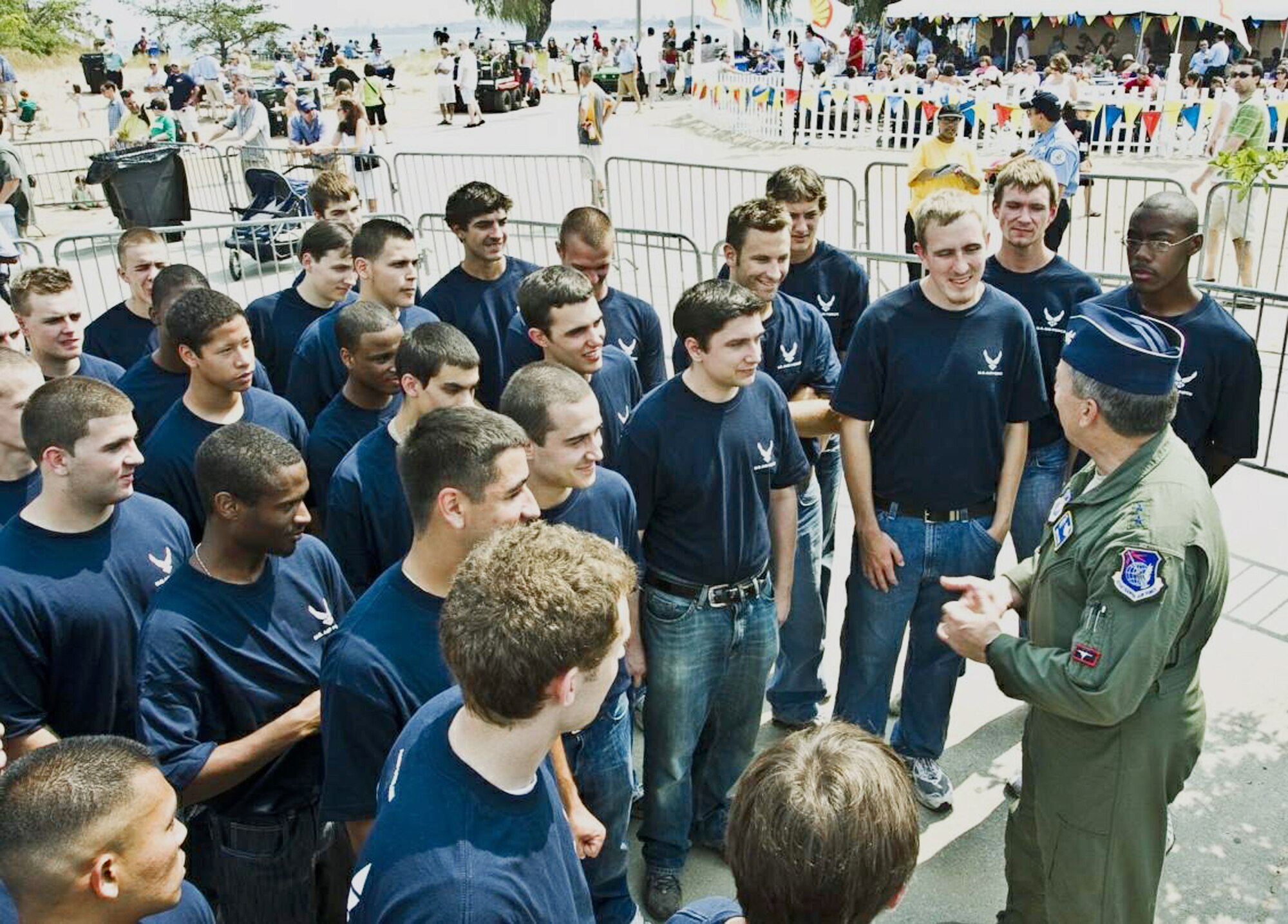 Recruits from the Chicago area listen as Maj. Gen. Gregory Feest, commander of Air Education and Training Command's 19th Air Force at Randolph Air Force Base, Texas, gives tips on achieving success in the Air Force.  Following the chat, General Feest conducted the oath of enlistment ceremony with the recruits on the Chicago lakefront Aug 15 in front of thousands of spectators attending the 51st Chicago Air and Water Show.  (U.S Air Force photo/AFROTC Cadet Raleigh Randolph)
