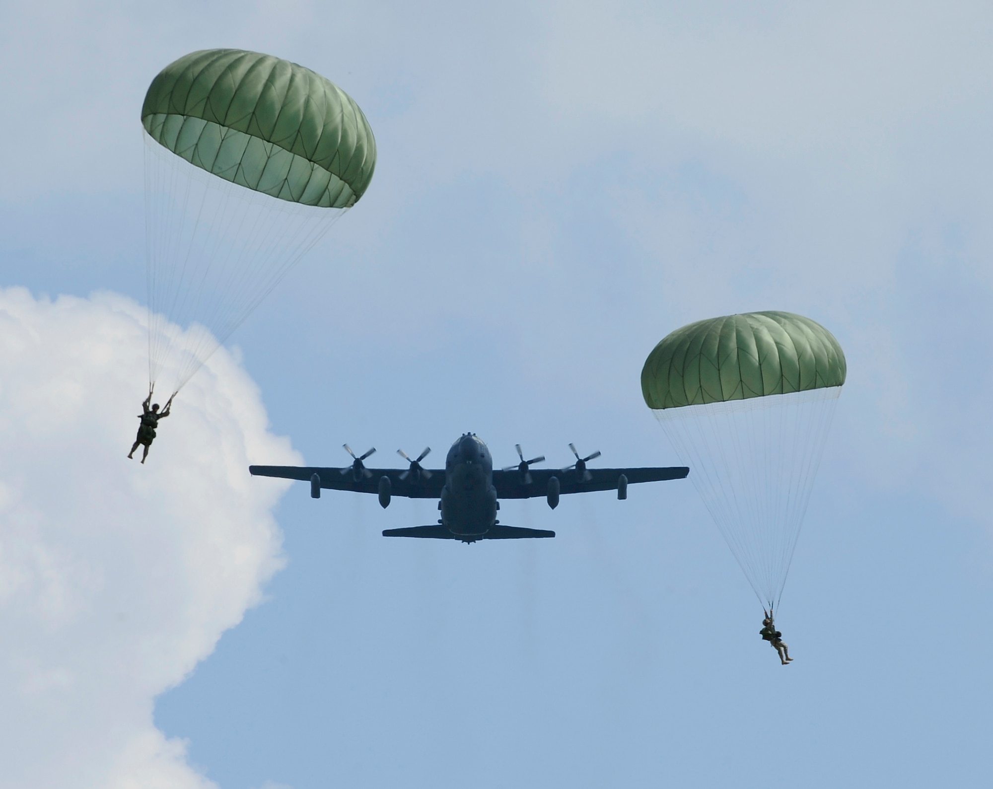 FORT BENNING, GA. ? Army Rangers descend by parachute as a U.S. Air Force MC-130 Combat Talon II assigned to the 15th Special Operation Squadron from Hurlburt Field, Fla., flies by during Ranger Rendezvous 2009 over Ft. Benning, Ga. More than 1,000 Rangers assigned to four Ranger battalions from across the country participated in a mass tactical jump flown by U.S. Air Force aircraft. (U.S. Air Force photo/Senior Airman Jason Epley)