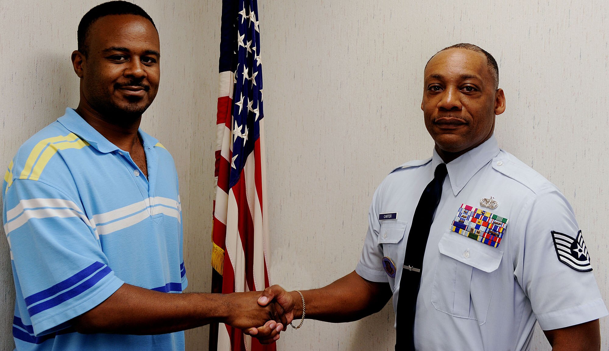 MOODY AIR FORCE BASE, Ga. – Tech. Sgt. David Carter, Moody’s Reserve recruiter, and Dwayne Corker, Air Force Reserve enlistee, shake hands after an oath of enlistment here Aug. 13. Mr. Corker is the 332nd enlistment for the Eastern Recruiting Squadron, and the 35th enlistment for Sergeant Carter, allowing him to reach his individual goal for 2009. Sergeant Carter reports to the Dobbins Recruiting Team.  (U.S. Air Force photo/Airman 1st Class Joshua Green)
