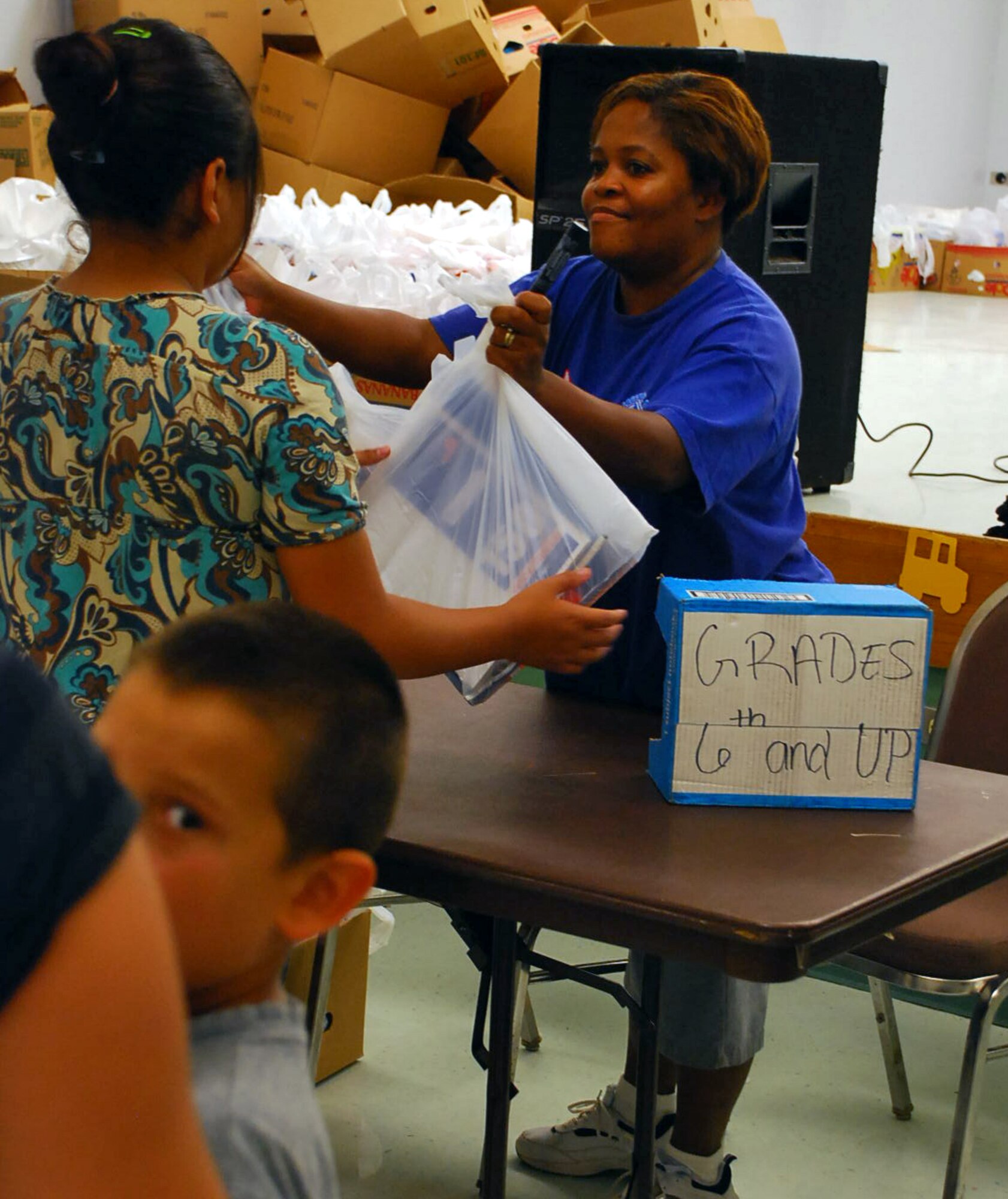 LAUGHLIN AIR FORCE BASE, Texas –Master Sgt. Monique Johnson, 96th Flying Training Squadron, helps hand out school supplies to children in the local community during the 3rd Annual Back-to-School Health Fair in Del Rio, Texas August 6. The fair provided more than 1800 students with a pair of shoes and more 3400 students with free school supplies, physical exams, haircuts and much more to the Del Rio community to help them get ready for the new school year that starts August 24. The event relied on nearly 200 volunteers and nearly half of which came from Laughlin to help set up, take down and ensure everything went smoothly, said Ray Torres, Laughlin’s exercise physiologist with the Health and Wellness Center event and volunteer coordinator. (U.S. Air Force photo by Senior Airman Sara Csurilla)