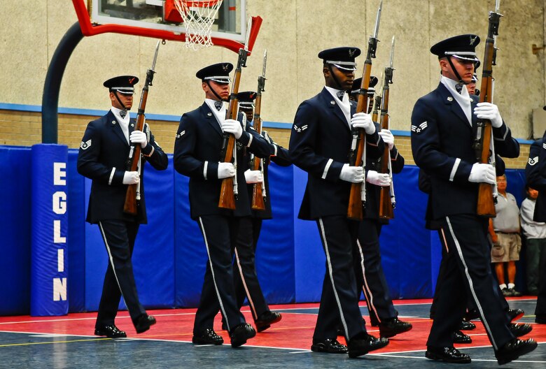The United States Air Force Honor Guard Drill Team demonstrates their 16-man performance at the Eglin Air Force Base, Fl., Youth Center gym Aug. 17. More than 100 children ranging from kindergarten to fifth grade attended the performance. (U.S. Air Force photo by Senior Airman Alexandre Montes)