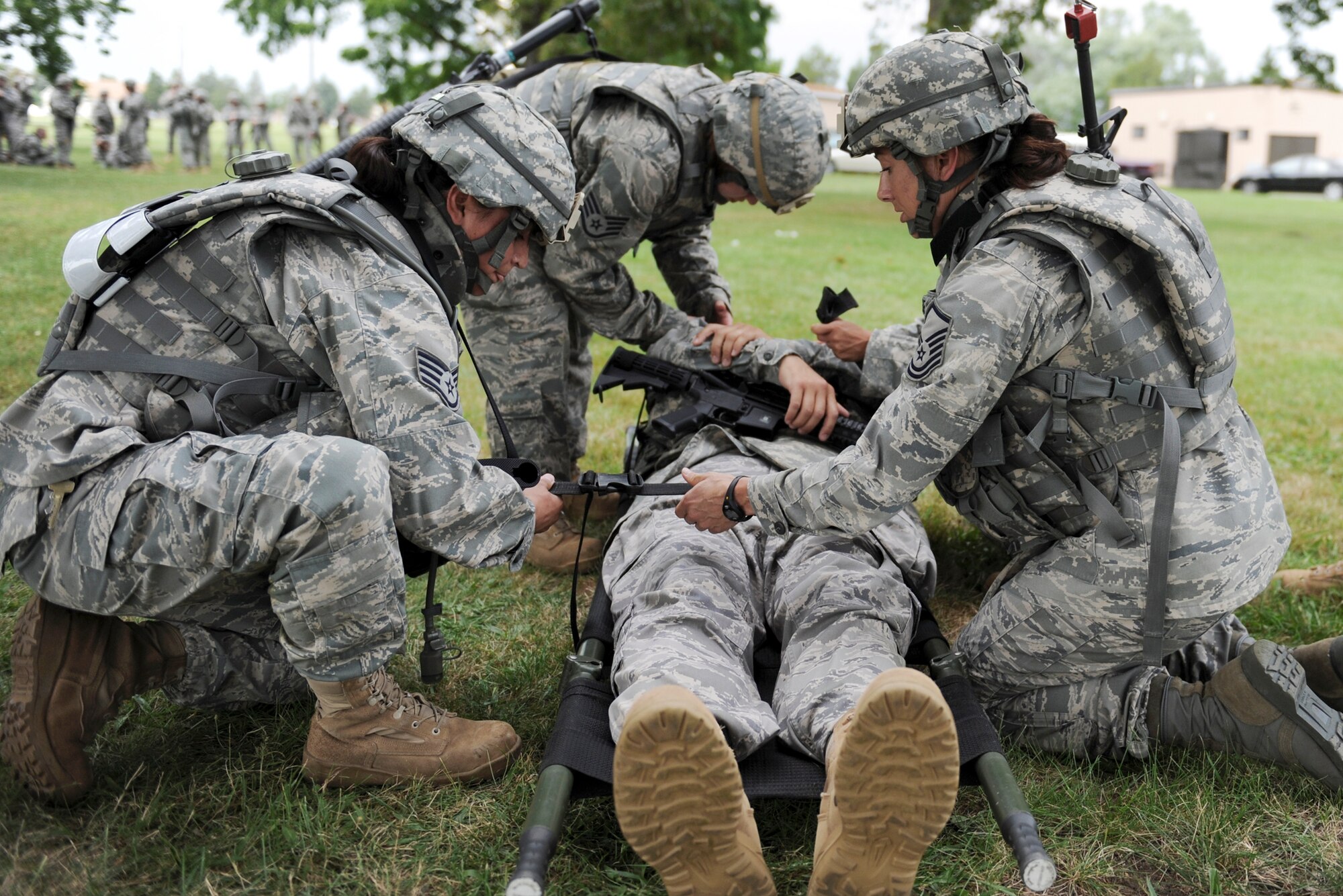 Master Sgt. Sarah Webb (right) assists Staff Sgt. Alondra Bayless to transport a "casualty" during simulated hostile scenarios at the combat lifesavers course July 29 at Fort Dix, N.J. Sergeant Webb is a public affairs superintendent assigned to the 100th Air Refueling Wing at Royal Air Force Mildenhall, England, and Sergeant Bayless is a traffic management craftsman assigned to the 60th Aerial Port Squadron at Travis Air Force Base, Calif. (U.S. Air Force photo/Senior Airman Larry E. Reid Jr.)