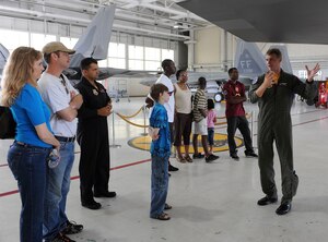 LANGLEY AIR FORCE BASE, Va. -- Maj. Dave "Zeke" Skalicky, F-22A Raptor Demonstration Team pilot, points out features of the F-22 to a group from Portsmouth Naval Hospital Pediatrics Oncology during a tour of the 27th Fighter Squadron Aug. 6. The group was invited to base for a special tour of the F-22 Raptor, the Air Traffic Control Tower, and an F-22 demonstration flight. (U.S. Air Force photo/Amn Rebecca Montez)