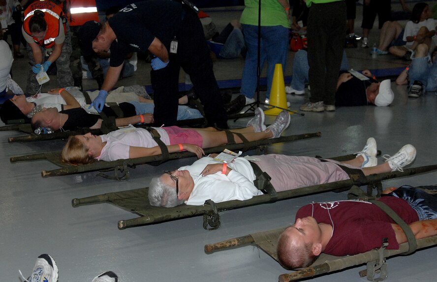 OFFUTT AIR FORCE BASE, Neb.- Offutt and local area volunteers with simulated injuries are given emergency medical treatment during the Major Accident Response Exercise in preparation for the 2009 "Defenders of Freedom" Open House and Air Show Aug. 15 at the Offutt Field House. The victims were later transported by emergency vehicles to nine local hospitals for further treatment. U.S. Air Force photo by Kendra Williams.