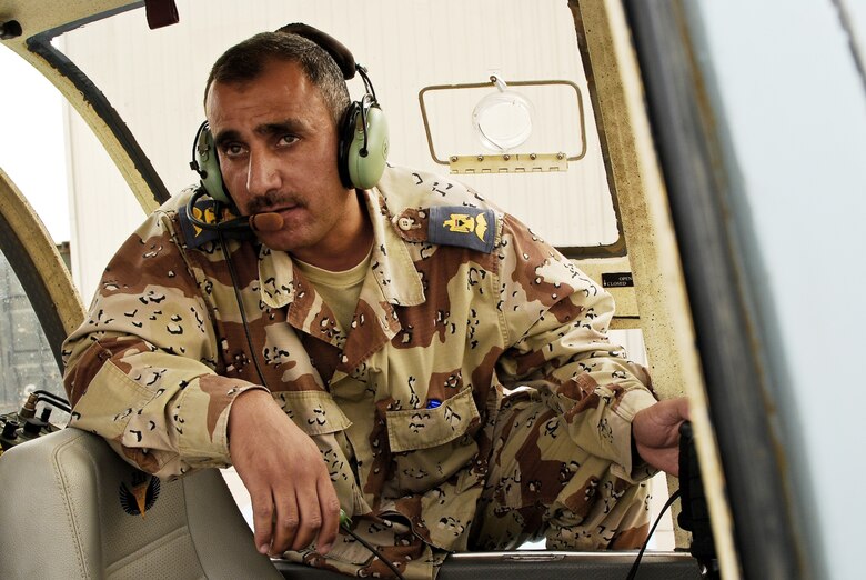 An Iraqi air force officer listens for a response from the Iraqi army in an effort to enhance communication between the two services Aug. 11 on Contingency Operating Base Basra, Iraq. American Airmen assisted with linking the Iraqi army and air force. (U.S. Army photo/Spc. Darryl L. Montgomery)