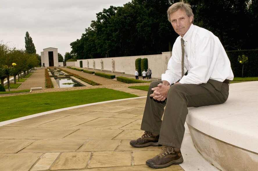 David Bedford sits in front of the Cambridge American Cemetery and Memorial's great mall Aug. 10 in Cambridge, England. Mr. Bedford is the superintendent of the Cambridge American Cemetery and Memorial and an American veteran. He's been the superintendent of the cemetery for 2.5 years and has worked for the American Battle Monuments Commission for 10 years. (U.S. Air Force photo/Staff Sgt. Nathan Gallahan)