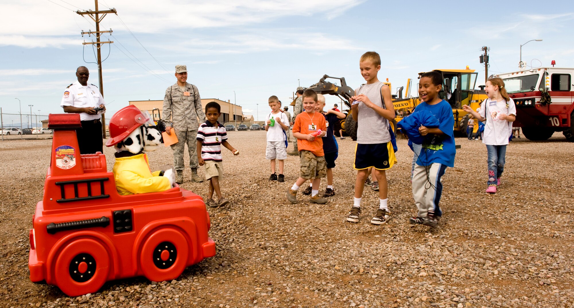 HOLLOMAN AIR FORCE BASE, N.M. -- Children "deployers" check out Sparkey the Fire Dog in his fire engine as part of the 49th Civil Engineer Squadron fire department display during Operation K.I.D., a mock deployment held at Basic Expeditionay Airfield Resources (BEAR) Base Aug. 14, for children of military members stationed here. (U.S. Air Force photo by Tech. Sgt. Alan Port)
