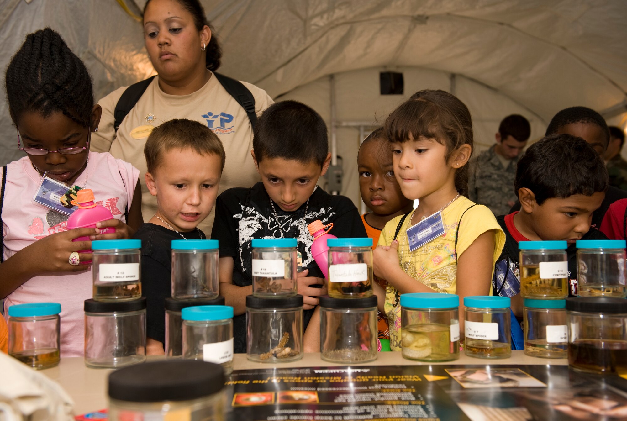 HOLLOMAN AIR FORCE BASE, N.M. -- Children check out the different bugs and animals at the 49th Medical Group Public Health display during Operation K.I.D. Aug. 14, here. The children spent time at Basic Expeditionary Airfield Resources (BEAR) Base before attending a base-wide hail and farewell. (U.S. Air Force photo by Tech. Sgt. Alan Port)