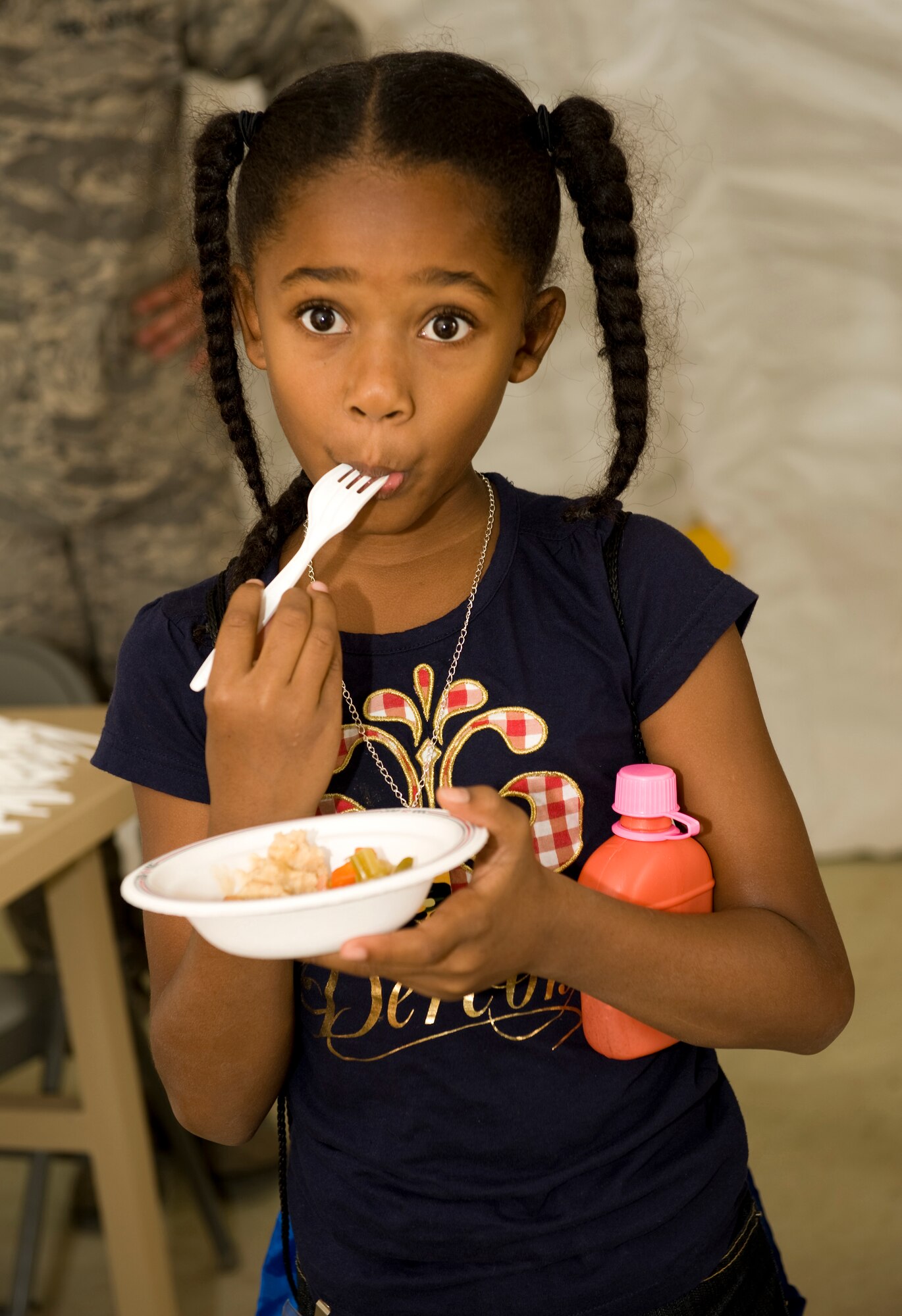 HOLLOMAN AIR FORCE BASE, N.M. -- Anevay Whyte tries the food in a deployed dining facility during Operation K.I.D. Aug. 14, at Basic Expeditionary Airfield Resources (BEAR) Base here. K.I.D. stands for Kids Investingating Deployment. (U.S. Air Force photo by Tech. Sgt. Alan Port)