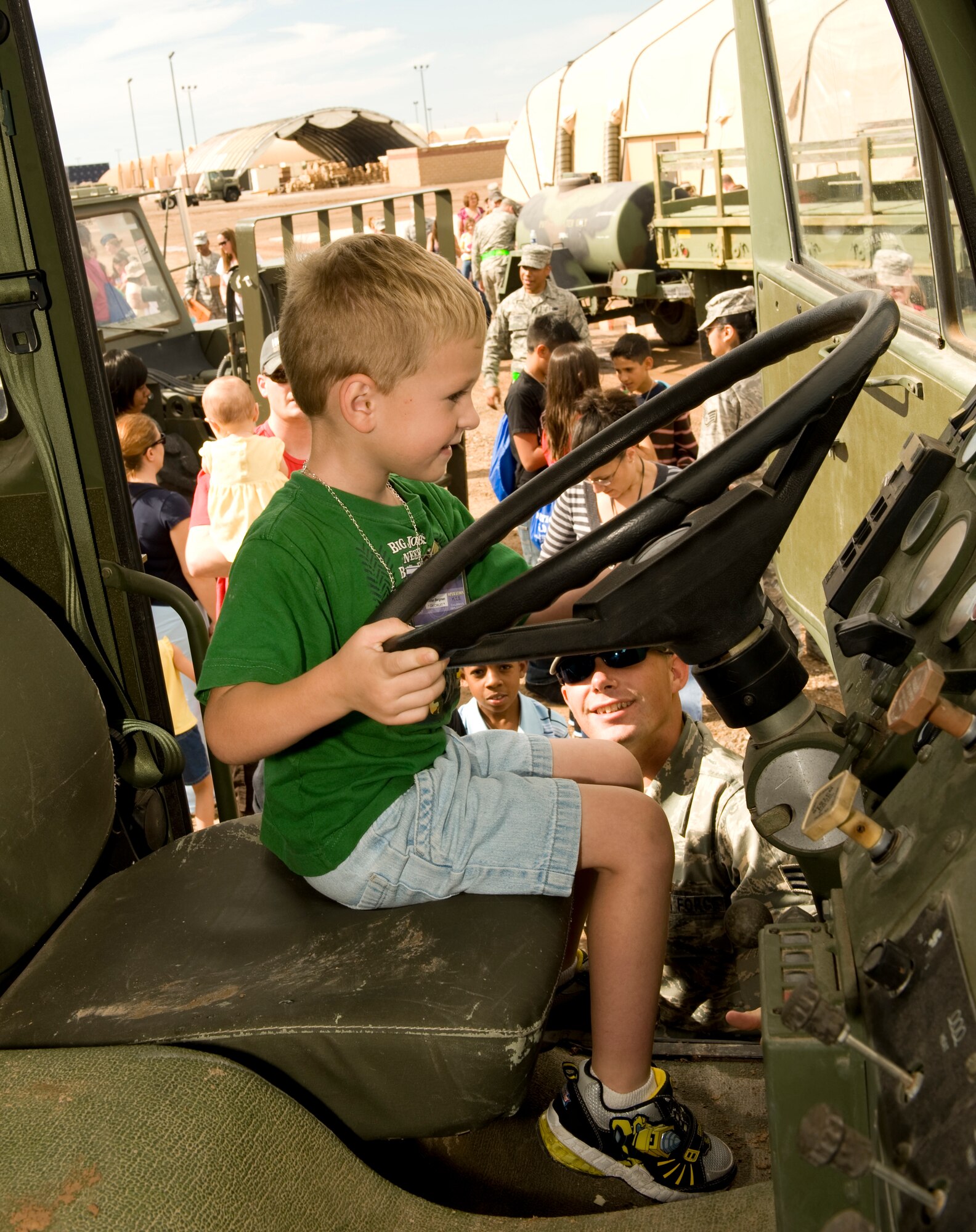 HOLLOMAN AIR FORCE BASE, N.M. -- Jaran Bergman checks out the controls of one of the trucks on display at Basic Expeditionary Airfield Resources (BEAR) Base during Operation K.I.D., a mock deployment for children of military members Aug. 14 here. The event allowed children to understand some of the things their parents do when they deploy. (U.S. Air Force photo by Tech. Sgt. Alan Port)