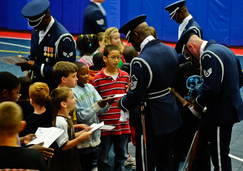 Members of the United States Air Force Honor Guard Drill Team take time to meet and sign autographs for children from the Eglin Air Force Base, Fl., Youth Center August 17. More than 100 children ranging from kindergarten to fifth grade attended the performance. (U.S. Air Force photo by Senior Airman Alexandre Montes)