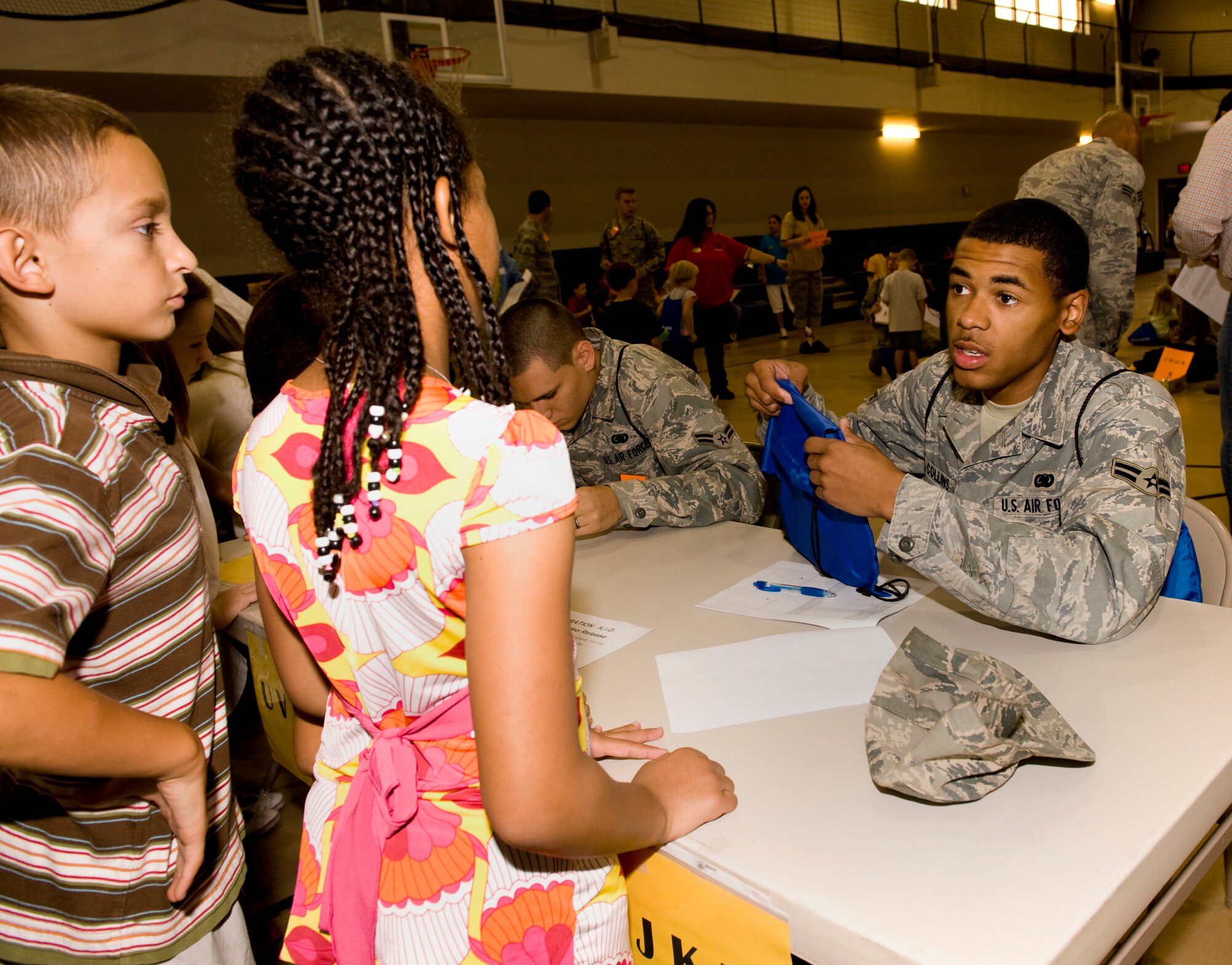 HOLLOMAN AIR FORCE BASE, N.M. -- Airman 1st Class Robert Collins, 49th Logistics Readiness Squadron, checks in kids during Operation K.I.D., a mock deployment held at Basic Expeditionary Airfield Resources (BEAR) Base here, Aug. 14. The event was designed for children of military members to help them understand deployments. (U.S. Air Force photo by Tech. Sgt. Alan Port)