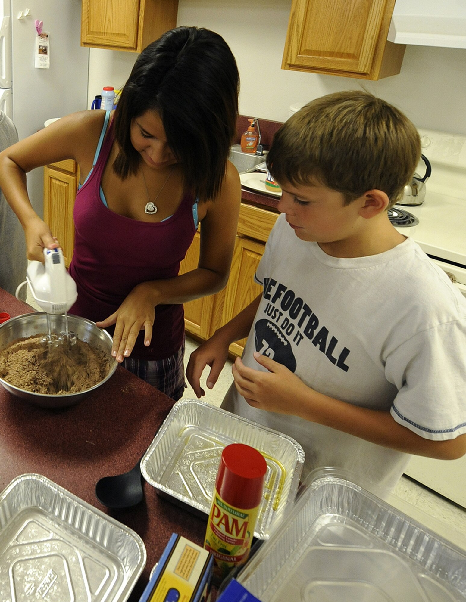 HOLLOMAN AIR FORCE BASE, N.M. -- Gabby Gonzales, 15, and Christopher Kotrous, 10, experiment with preparing healthier variations of popular snacks such as brownies at the Health and Wellness Center here Aug. 13. The goal of the camp was to make health a priority at a young age and promote a healthy lifestyle with the idea that prevention -- not intervention -- is the key. (U.S. Air Force photo by Senior Airman Tiffany Trojca)