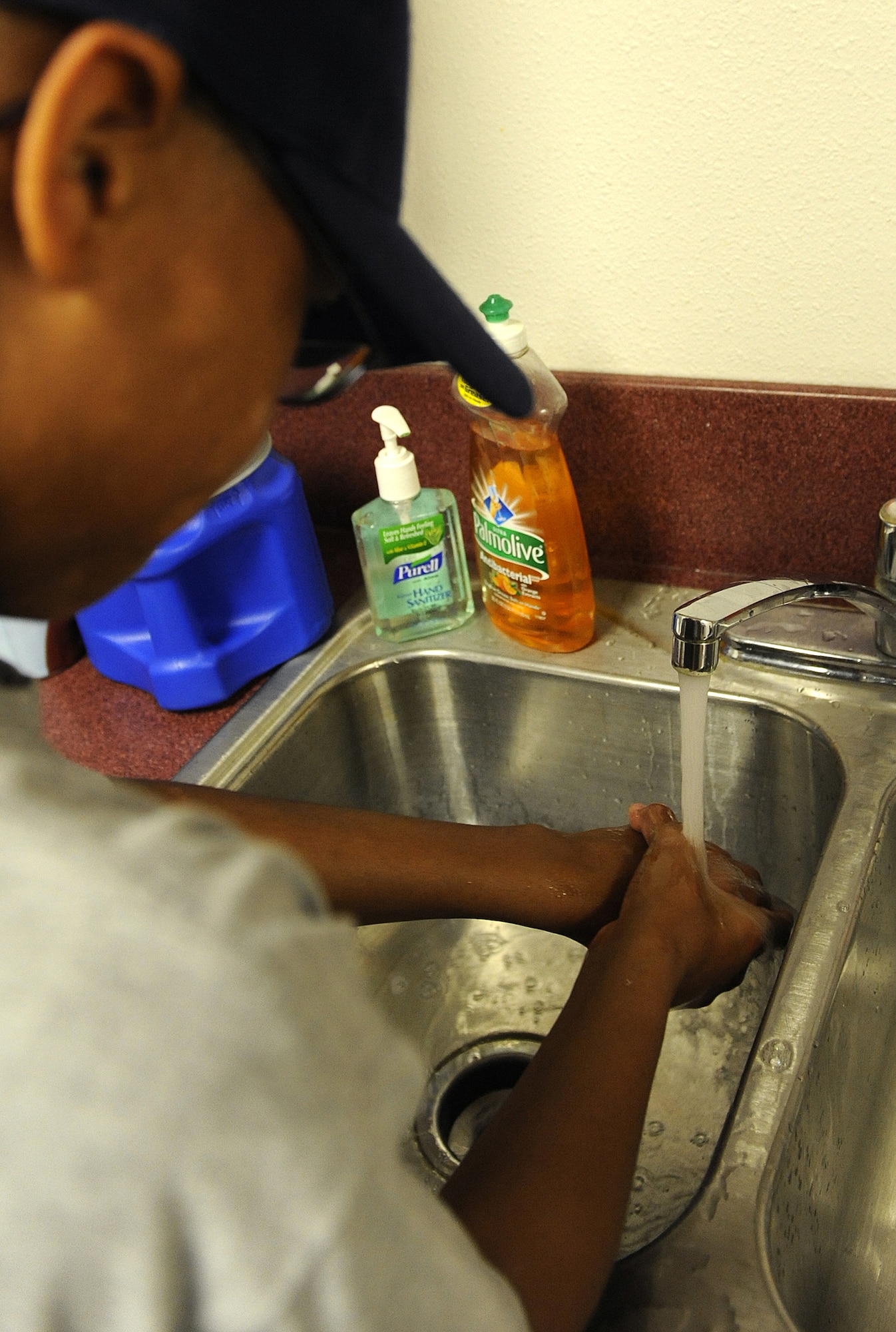 HOLLOMAN AIR FORCE BASE, N.M. -- Sadeyshus Sweets, 13, washes his hands prior to handling food at the Health and Wellness Center here Aug. 13. During the two-week Teen Health and Wellness Camp, pre-teens and teens learned about living a healthy lifestyle that involves proper nutrition and exercise. (U.S. Air Force photo by Senior Airman Tiffany Trojca)