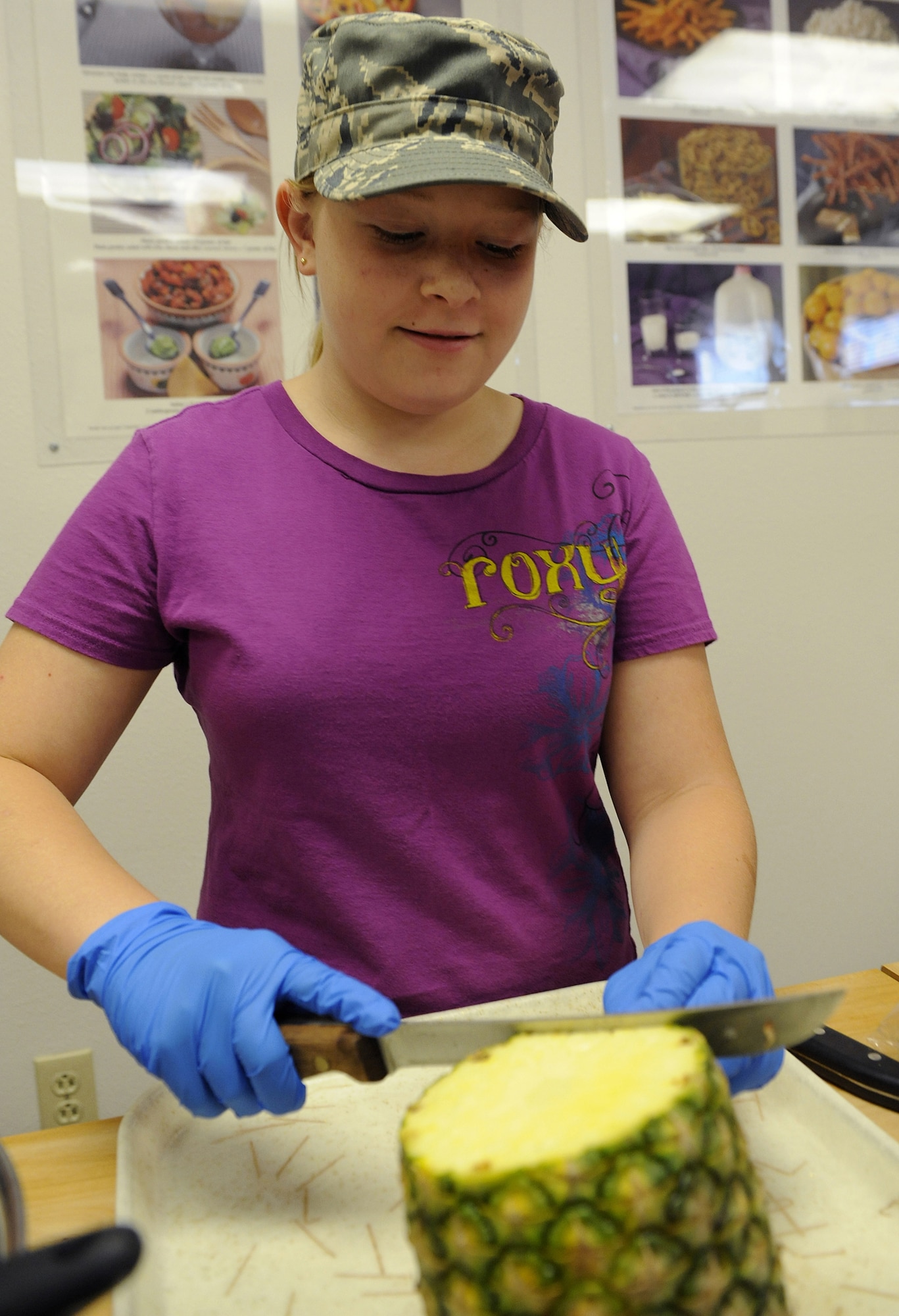 HOLLOMAN AIR FORCE BASE, N.M. -- Hanna Stizer, 13, cuts a pineapple at the Health and Wellness Center here Aug. 13. During the two-week Teen Health and Wellness Camp, pre-teens and teens learned about living a healthy lifestyle. (U.S. Air Force photo by Senior Airman Tiffany Trojca)