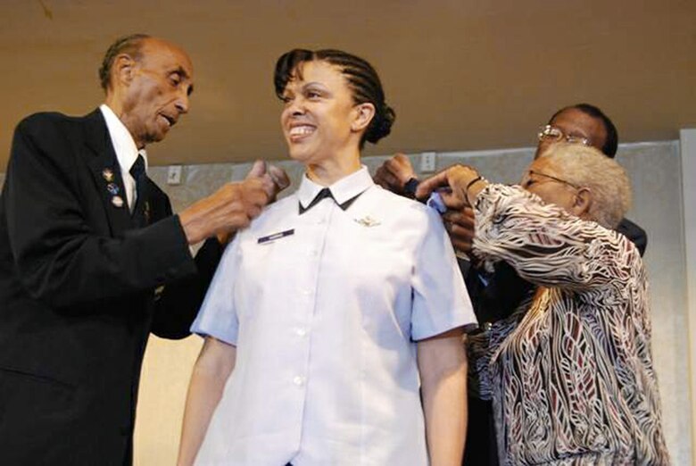 Oliver Goodall, retired Brig. Gen. Leon A. Johnson, and retired Army Maj. Nancy C. Leftenant-Colon pin brigadier general stars on Brig. Gen. Stayce D. Harris during the 38th Annual Tuskegee Airmen, Inc., convention Aug. 7 in Las Vegas. The Air Force's highest ranking black female aviator, General Harris is currently based at the Pentagon as the assistant to the U.S. Africa Command commander. General Johnson is the former mobilization assistant to the Headquarters Air Education and Training Command director of operations, Mr. Goodall is an original Tuskegee Airman, and Major Leftenant-Colon is the first black nurse in the Reserve or active-duty Army nurse corps. (U.S. Air Force photo/Tech. Sgt. Amaani Lyle) 