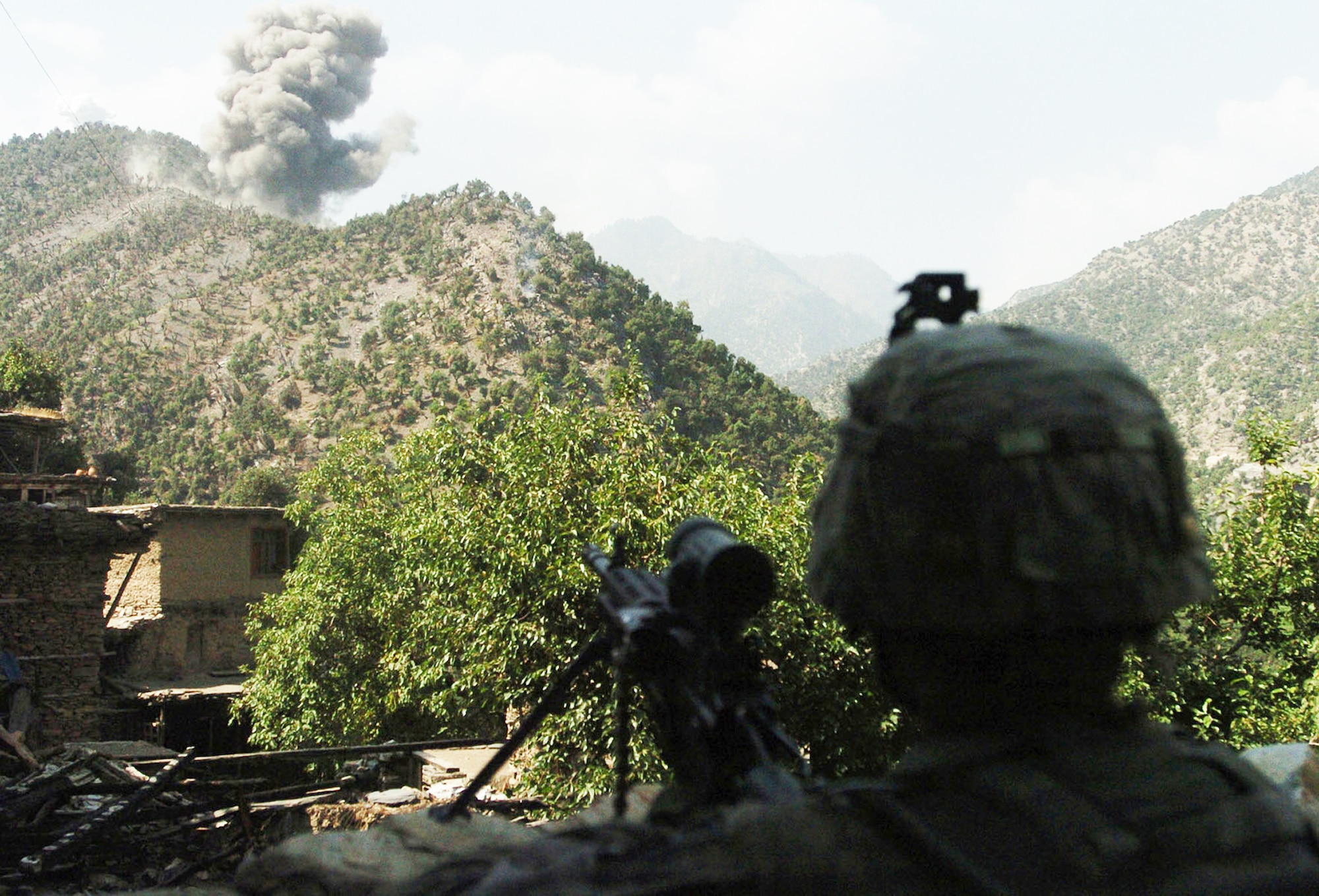 A U.S. Army Soldier watches as Air Force F-15E Strike Eagles bomb insurgent positions after a 20-minute gun battle in the Korengal Valley of Afghanistan's Kunar Province Aug. 13.  U.S. servicemembers from Company B, 2nd Battalion, 12th Infantry Regiment, 4th Brigade Combat Team, 4th Infantry Division, routinely engage insurgents in the volatile valley.  International Security Assistance Force troops across Afghanistan have increased operations in recent months, in order to ensure safety and security during Afghanistan's second national election, scheduled for the end of August. (U.S. Army photo/Sgt. Matthew Moeller)