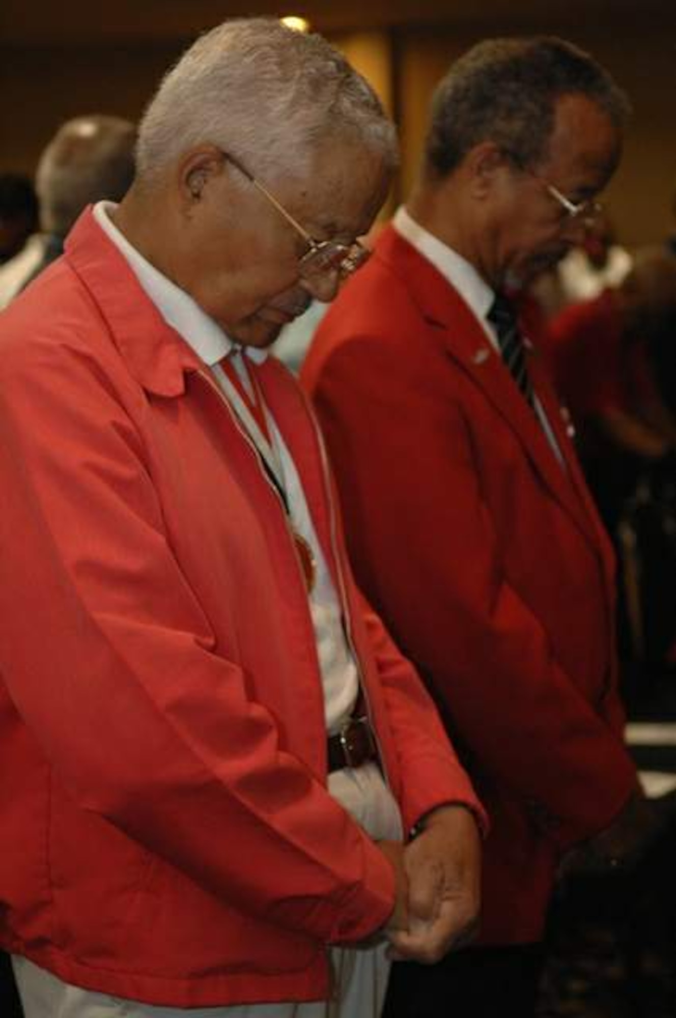 Original Tuskegee Airman and retired Col. Charles McGhee (left) bows his head in prayer next to retired Lt. Gen. Russell C. Davis during the Lonely Eagles Ceremony at the 38th Annual Tuskegee Airman, Inc. convention Aug. 7 in Las Vegas. Colonel McGhee joined the Army in 1942 and is a veteran of World War II, the Korean War and Vietnam. He flew 409 combat missions during his time in the Air Force and was formerly TAI's national president. General Davis is the Tuskegee Airman, Inc., national president. TAI is a non-profit organization dedicated to honoring the accomplishments of the African-American air, ground and operations crew members in the Army Air Corps during World War II. (U.S. Air Force photo/Senior Airman Joseph Araiza) 