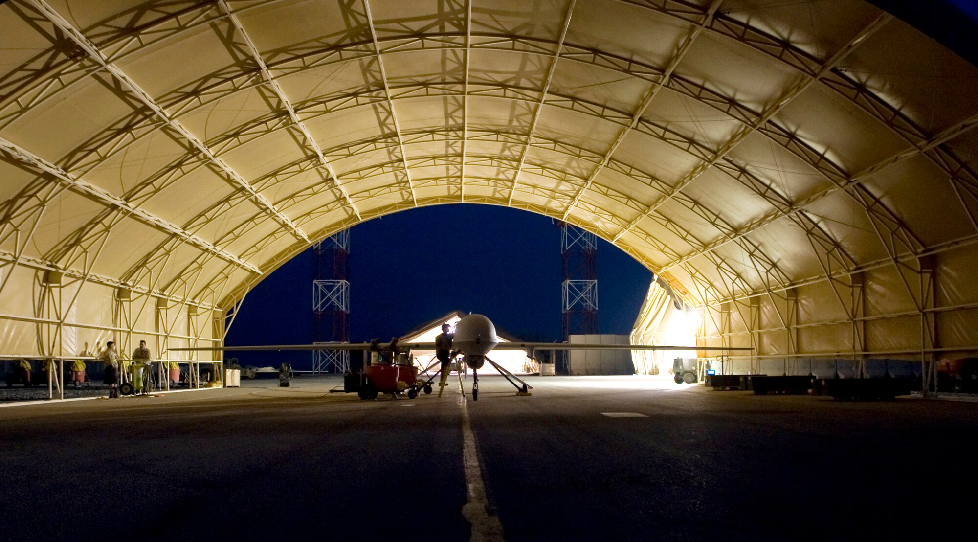 An MQ-1 Predator goes through post-flight maintenance in Iraq. The Predator provides integrated and synchronized close-air combat operations, including intelligence, surveillance and reconnaissance, to ground commanders. (U.S. Air Force photo)
