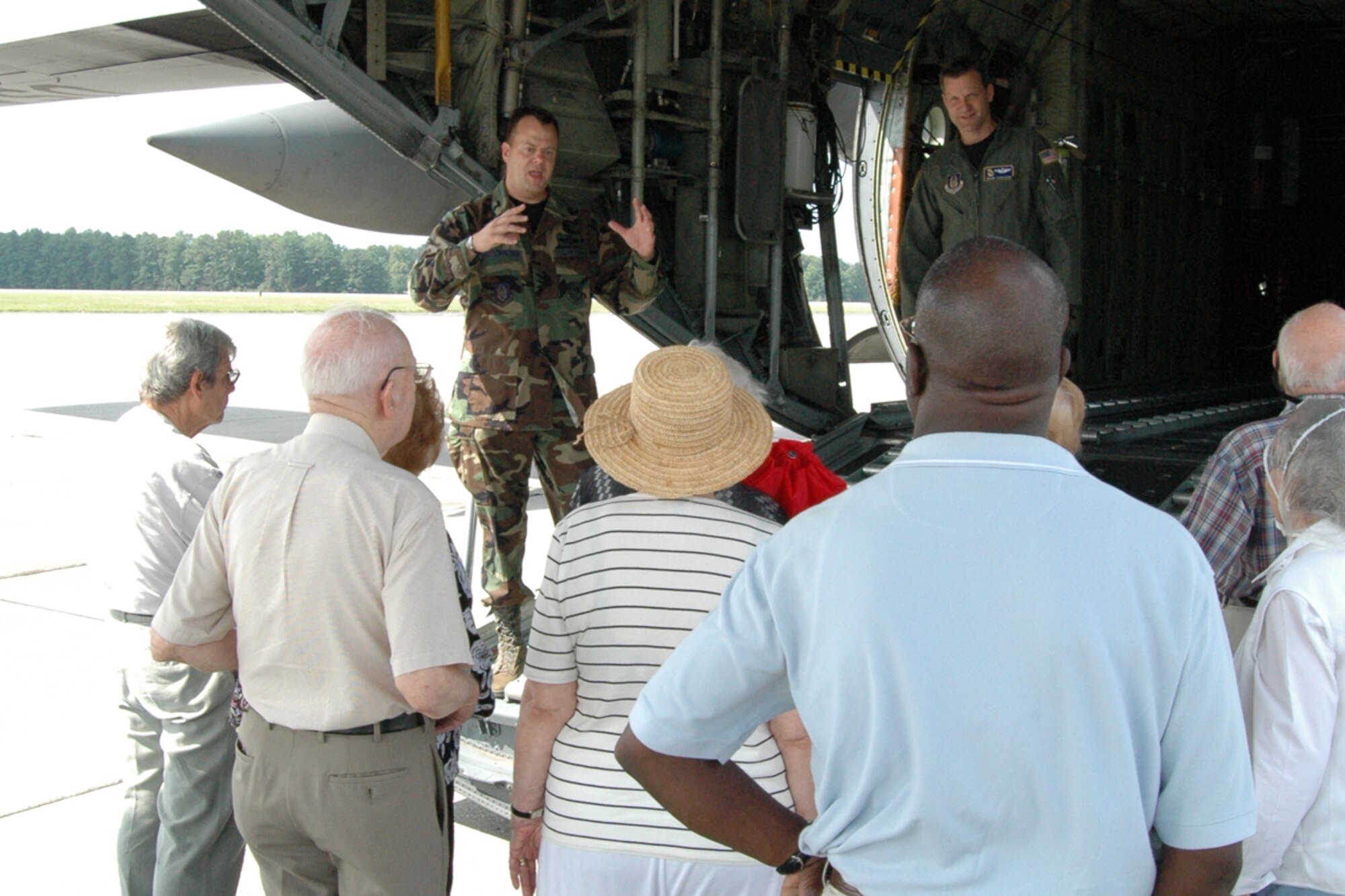Senior Master Sgt. John L. Grutzmacher, aircraft loadmaster, 94th Aerial Delivery Flight and Maj. Brian E. Ferguson, instructor pilot, 700th Airlift Squadron give a tour of a C-130 Hercules to members of the Saint Anne's Terrace Retirement Community during a base visit Aug. 14. (U.S. Air Force photo/Senior Airman Shaun Shenk)
