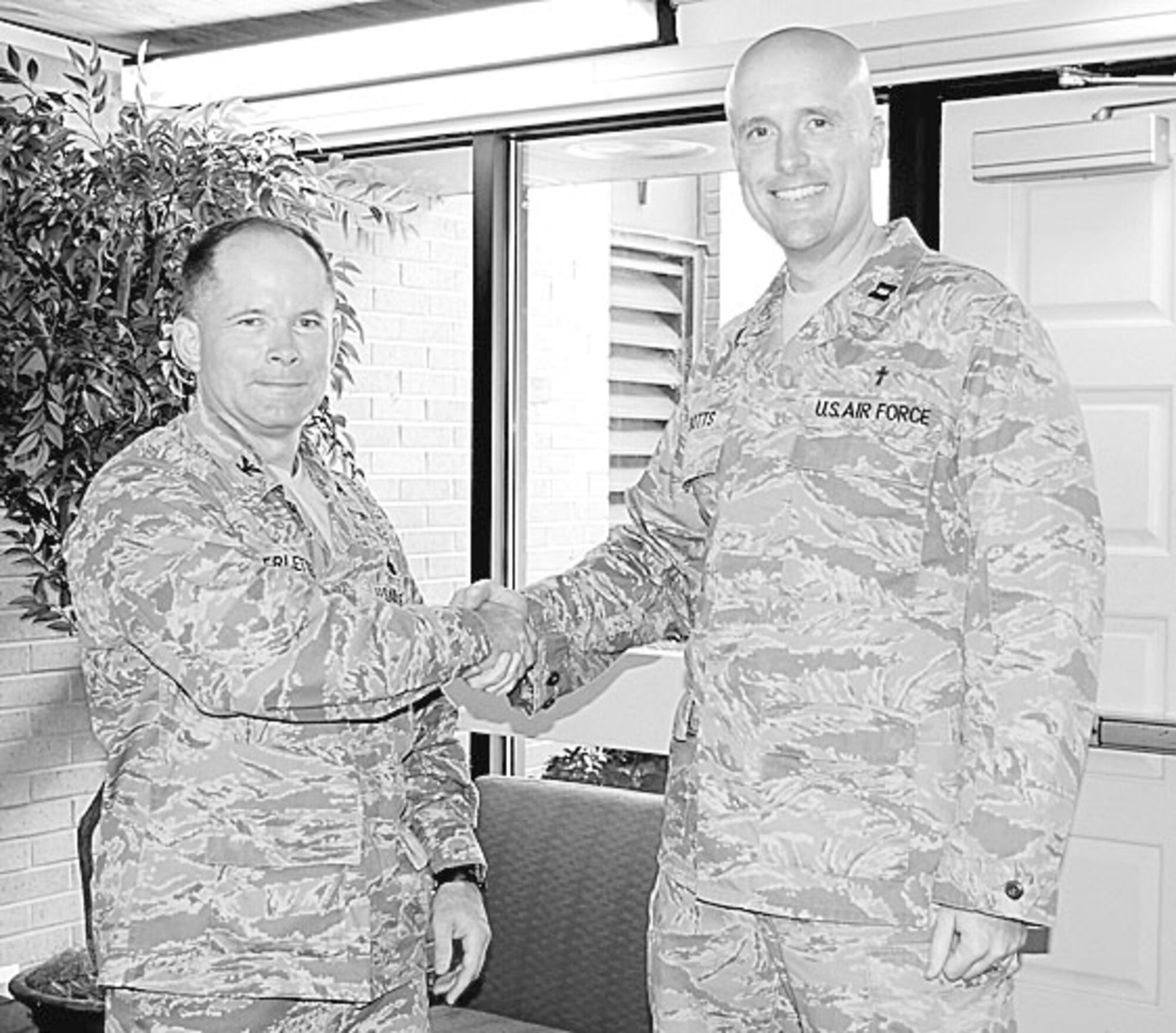 Col. Craig Berlette, 43rd Airlift Wing Vice Commander, recognizes Chaplain (Capt.) Jason Botts, 43rd AW, for his outstanding work in the chapel and throughout Pope’s community. (U.S. Photo by Airman 1st Class Mindy Bloem)