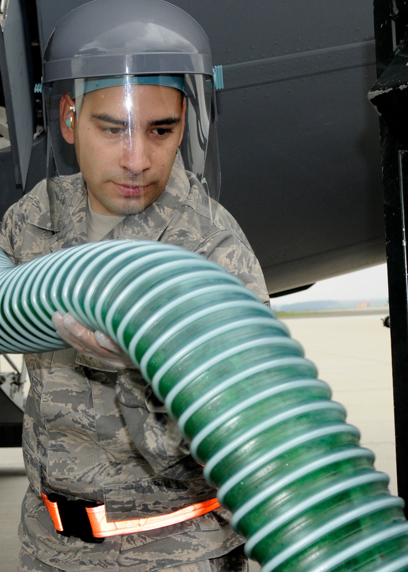 SPANGDAHLEM AIR BASE, Germany – Staff Sgt. Jesus Macias, 726th Aircraft Mobility Squadron air transportation journeyman, positions the waste hose during a routine latrine service on a C-17 Globemaster Aug 13. (U.S. Air Force photo by Airman 1st Class Staci Miller)