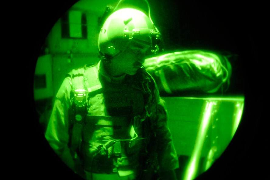 Tech. Sgt. Wayne Witter, a C-130J Super Hercules loadmaster assigned to the 772nd Expeditionary Airlift Squadron at Kandahar Air Field, Afghanistan, prepares for a night airdrop to deliver JP-8 fuel to troops on the ground in southwestern Afghanistan on July 17, 2009. (U.S. Air Force Photo/Staff Sgt. Shawn Weismiller) 