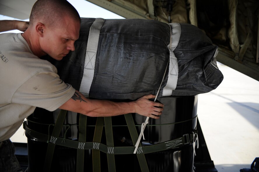 U.S. Army Sgt. Joseph Brack, 612th Quartermaster Company, guides a pallet into the cargo bay of a C-130J Super Hercules, in preparation for a night airdrop to deliver JP-8 fuel to troops on the ground in southwestern Afghanistan on July 17, 2009. (U.S. Air Force Photo/Staff Sgt. Shawn Weismiller) 